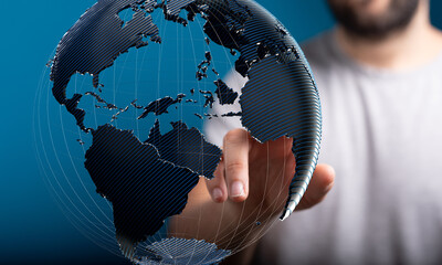 High-quality stock photo of a hand interacting with a digital 3D model of planet Earth, symbolizing...