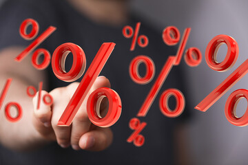 Abstract image of a hand interacting with 3D percentage symbols. Perfect for finance, sales, and...