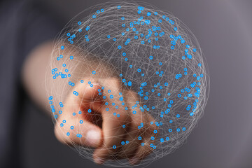 Abstract image of a hand interacting with a digital sphere representing global network connections.