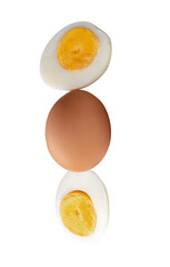 Top view of raw chicken egg and peeled cooked or boiled egg with egg yolk in two halves in stack isolated with clipping path in png file format
