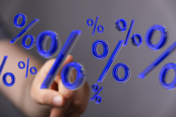 A hand interacts with a 3D percentage symbol, representing discounts, interest rates, or financial...