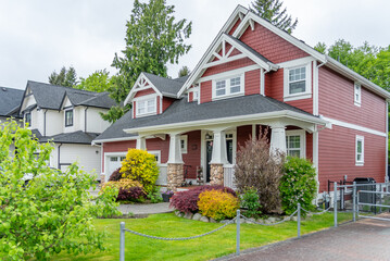 Two story stucco luxury house with nice spring blossom landscape in Vancouver, Canada, North America. Day time on May 2025.