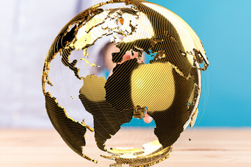 Image of a golden globe, symbolizing international business, networking, and global reach.