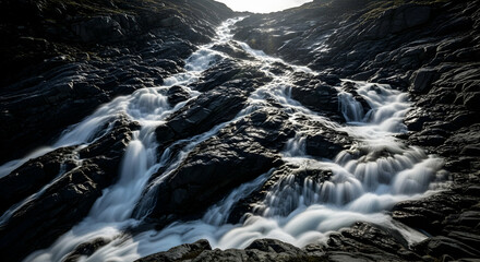 Cascading Water Flowing Over Rocks Underneath Mountain During Daylight