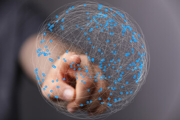 Abstract image of a hand interacting with a digital sphere, representing global network connections...