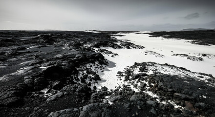 Dramatic Monochrome Landscape Featuring Contrasting Black Lava Fields and White Snow