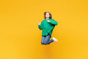Full body young happy woman she wear green sweatshirt casual clothes jump high point index finger...