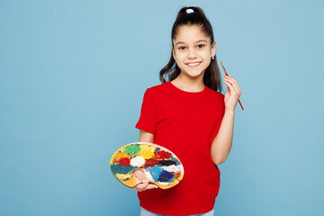 Little kid girl 8-9 years old wearing red t-shirt have fun hold in hand palette paint isolated on...