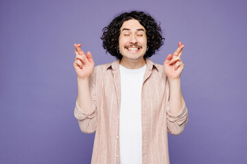 Young brunet man he wears pink shirt t-shirt casual clothes waiting for special moment, keeping...