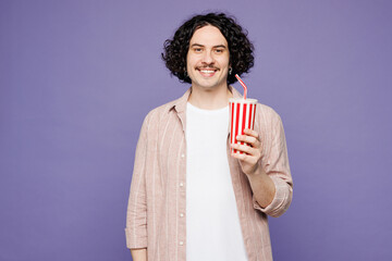 Young smiling happy man he wearing pink shirt t-shirt casual clothes hold in hand cup of soda pop...