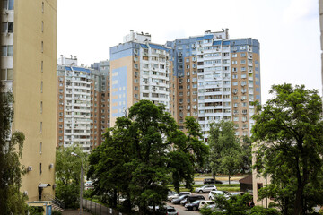 Kyiv Ukraine 4 June 2025 Apartment buildings with a mix of colors, surrounded by green trees under...