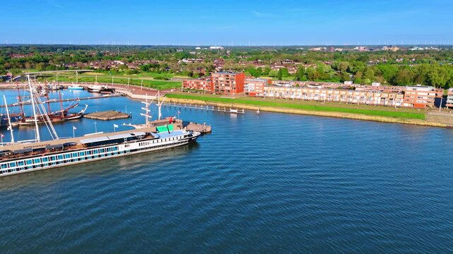 Ships on the waterscape of lake Markermeer in Lelystad, the Netherlands. Aerial view on the green city on sunny day.
