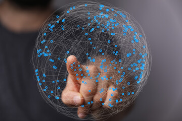 Abstract image of a hand interacting with a digital sphere representing global network connections...