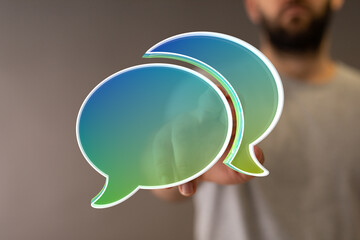 Abstract image of two speech bubbles, representing communication, conversation, and dialogue.