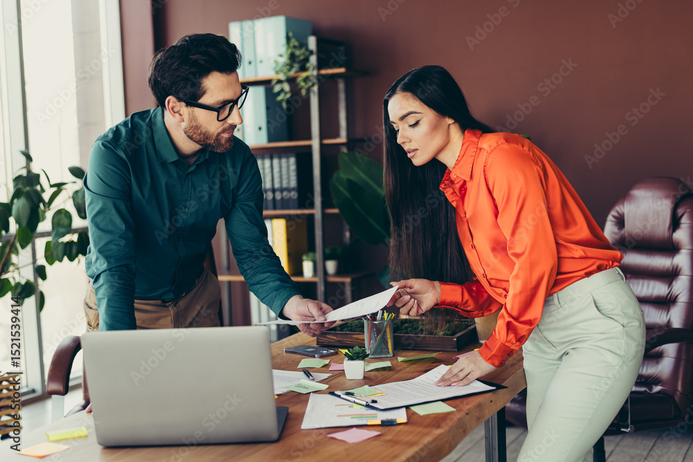 Aufkleber two elegant professionals collaborating in a vibrant workspace discussing documents and strategies f