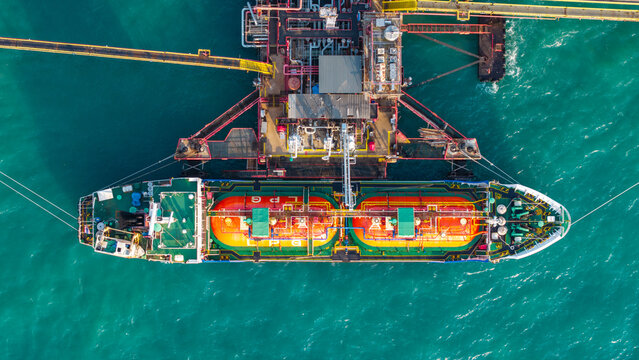 LNG (Liquified Natural Gas) tanker anchored in Gas terminal gas tanks for storage. Oil Crude Gas Tanker Ship. LPG at Tanker Bay Petroleum Chemical or Methane freighter export import transportation