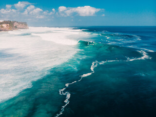 Drone shot of surfing waves in Uluwatu, Bali