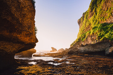 Cliff with rocks, stones, ocean and sunset tones in Bali, Uluwatu