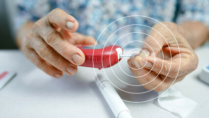 Close-up of elderly woman using red glucometer to check blood sugar after finger prick...