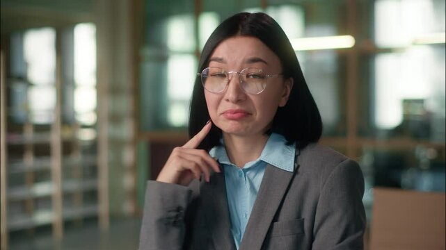 Asian business woman thinking pensive businesswoman Chinese Korean girl in office think employer female Japanese architect thoughtful puzzled search brainstorm no answer shrugging shoulders uncertain