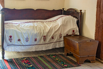 Old bed with white bedspread in a historic room