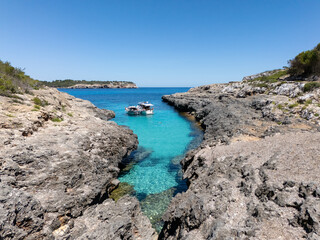 Boats anchored in turquoise channel leading to the open Mediterranean - View of anchored boats in...