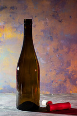 bottle of white wine with corkscrew and blurred abstract background