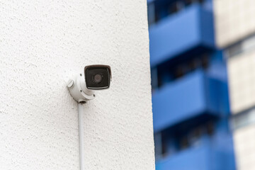Urban Security Camera on Wall with City Building