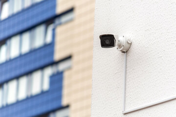 Urban Security Camera on Wall with City Building