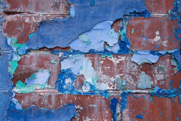 Abstract closeup of blue, peeling paint on an old brick wall in St. John's, Newfoundland

