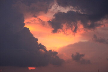 The sky is orange, covered with black clouds.