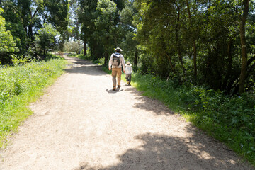 Fototapeta premium Father and son hiking together on sunny summer day