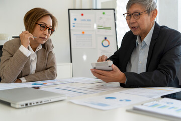 Senior businessmen calculating investment.