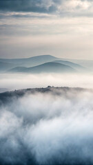 Misty mountain landscape serene scene with mountains partially obscured by low clouds and fog