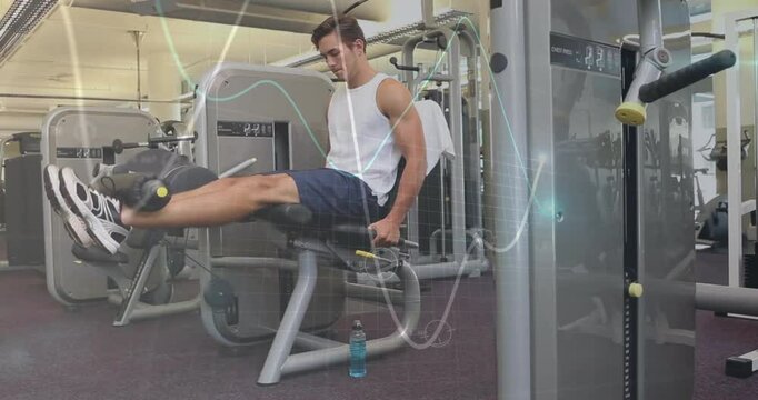 Man adjusting seat and gripping handles, initiating leg extension for quad strengthening in gym