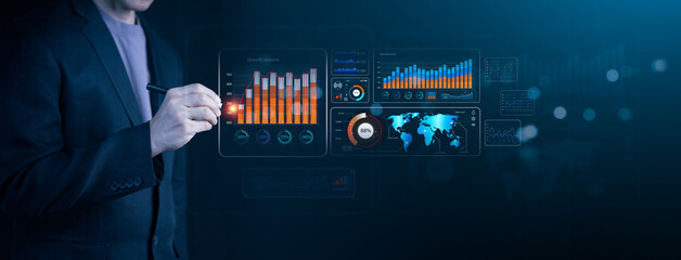 Businessman analyzing digital data and growth analytics on futuristic dashboard. Big data, technology and interactive data visualization for business success.