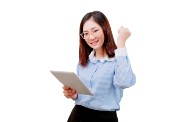 Asian young beautiful woman in glasses holding a tablet and making a triumphant gesture with her fist.