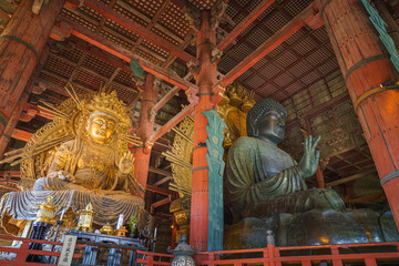 Nara, Japan - Sep 26 2024, Panoramic view of the Sitting Buddha Vairochana, a fifteen-meter bronze statue of Buddha, and a side-standing gilded statue of Buddha, at Todaiji Temple, Nara, Japan