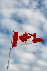 Canada flag with cloudy sky background