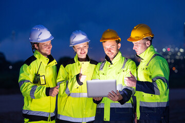 Engineers Reviewing Data at Industrial Site at Night