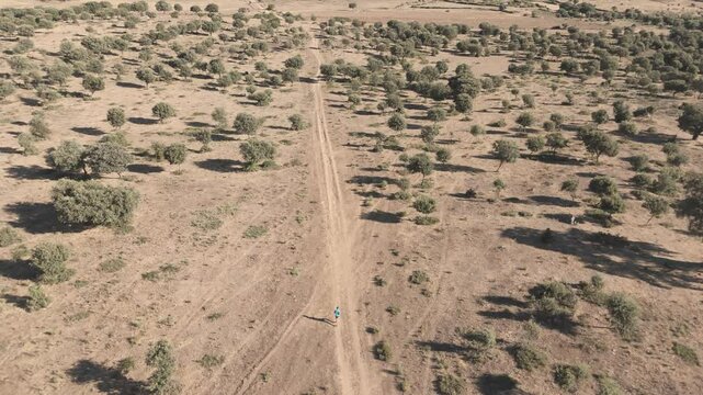 Drone Shot of a Runner Running Through Natural Landscape