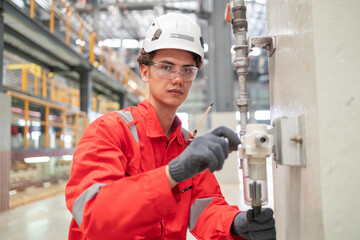 Technician Adjusting Industrial Valve in Factory