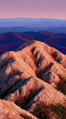 Majestic mountain range lit by soft evening sunlight in a stunning landscape setting
