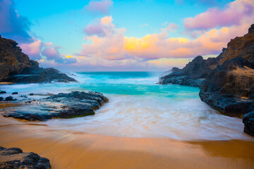 Dreamy secret beach in Hawaii with turquoise waves, volcanic rock, and pastel sunrise skies. Captures untouched coastal beauty, serenity, and tropical escape in a painterly natural scene.
