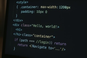Close-up of computer screen displaying HTML and JavaScript code, representing web development and programming concepts.