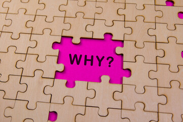 Empty puzzle piece with the word why printed inside