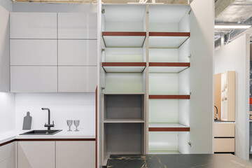 large corner built-in kitchen with upper and lower cabinets. Modern kitchen in light grey with...