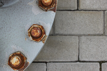 Corrosion of connecting bolts on a heavy steel hatch of a gas pipe flat lay image with copy space