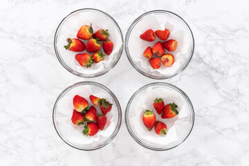 Fresh and Moldy Strawberries in a Glass Bowl on a White Napkin