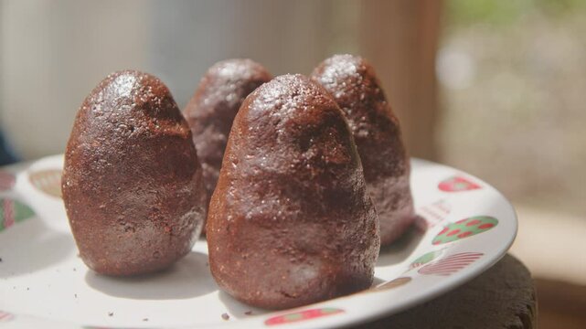 May 25, 2024: Ato Mayor, Dominican Republic, handmade traditional chocolate balls made from ground cacao displayed on table